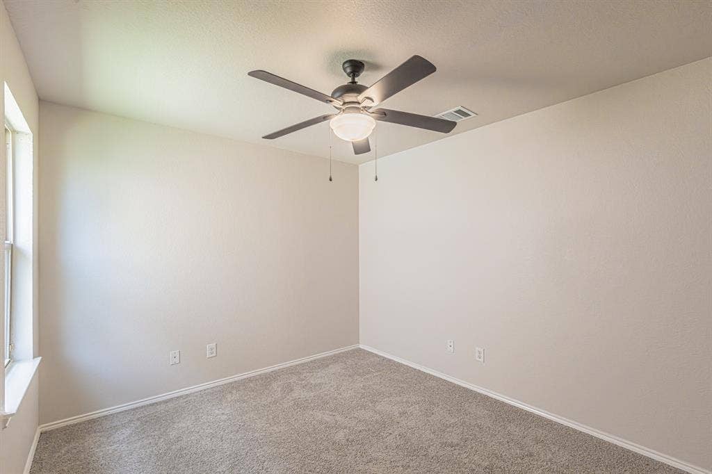 Neutral-toned walls complement plush carpet flooring