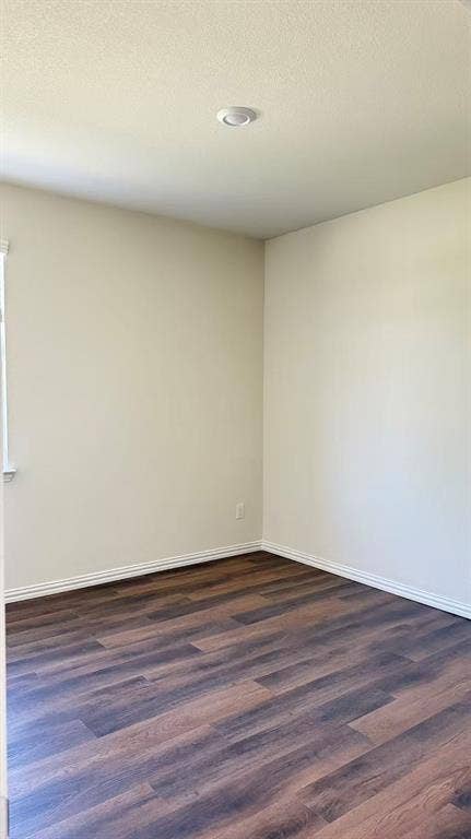 Neutral wall paint, recessed ceiling lighting, and wood-finish flooring