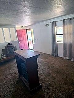 304 11th Street, Abernathy, TX 79311 Interior space featuring neutral wall tones, textile floor covering, a multi-panel exterior door, and an open railing partition