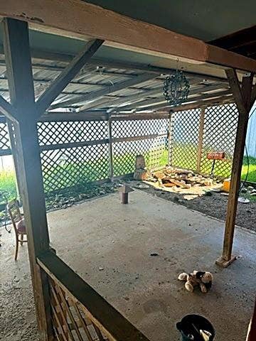 304 11th Street, Abernathy, TX 79311 Covered outdoor patio with a concrete floor, timber frame structure, and wood lattice privacy screening