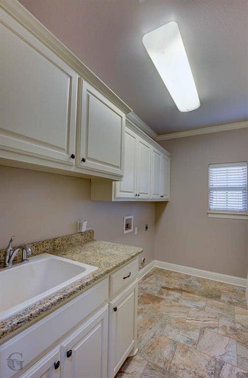 206 Tymark Drive, Bossier City, LA 71112 Laundry room with utility sink and lots of cabinets for extra storage