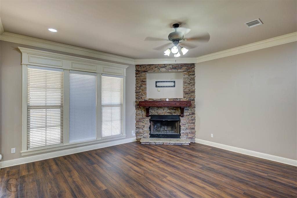 206 Tymark Drive, Bossier City, LA 71112 Living room with corner fireplace, beautiful millwork around window crown molding and laminate wood flooring.