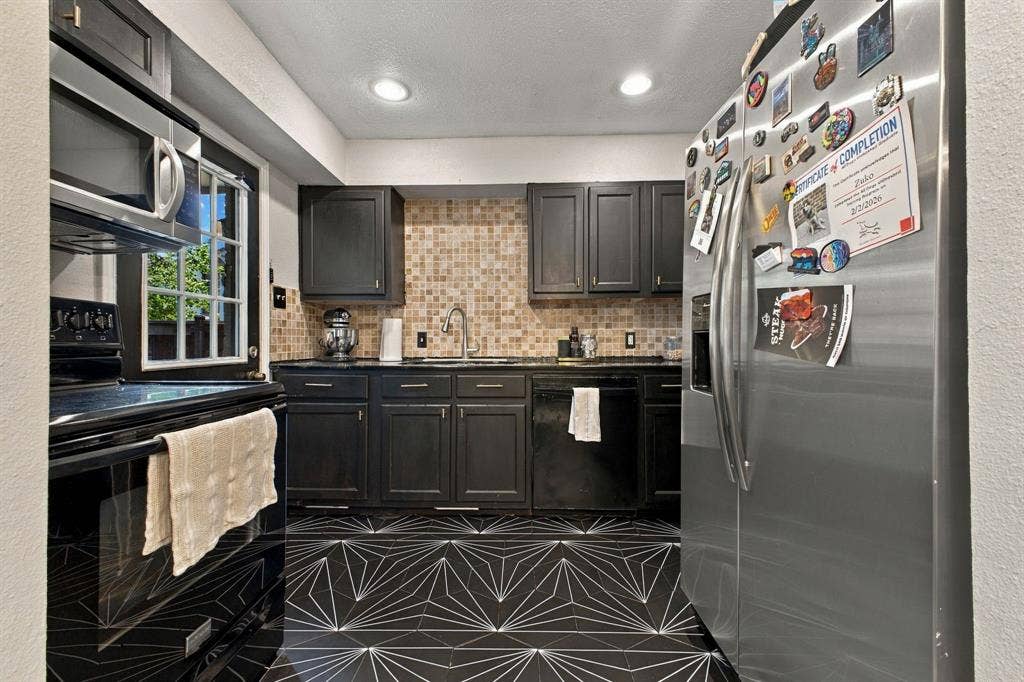4904 Lahoma Street, #4904, Dallas, TX 75235 Kitchen featuring dark cabinetry, geometric-patterned tile flooring, stone-tiled backsplash, recessed lighting, and stainless steel appliances