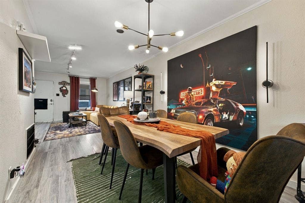4904 Lahoma Street, #4904, Dallas, TX 75235 Multi-light sputnik chandelier, wood-finish flooring, adjustable track lighting, and vertical wall-mounted accent fixtures