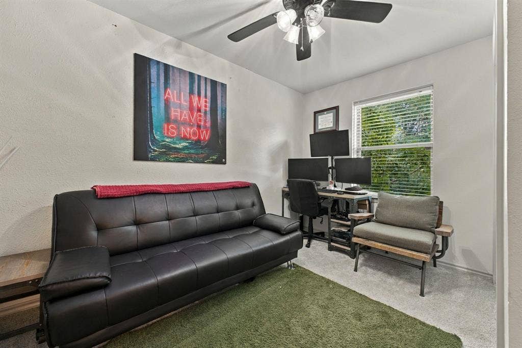 4904 Lahoma Street, #4904, Dallas, TX 75235 Room featuring neutral-toned carpeting, a multi-blade ceiling fan with integrated lighting, and a window with horizontal blinds