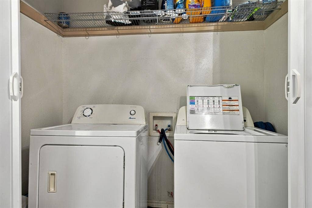4904 Lahoma Street, #4904, Dallas, TX 75235 Laundry closet featuring sliding white doors, wire shelving, and dedicated plumbing hookups