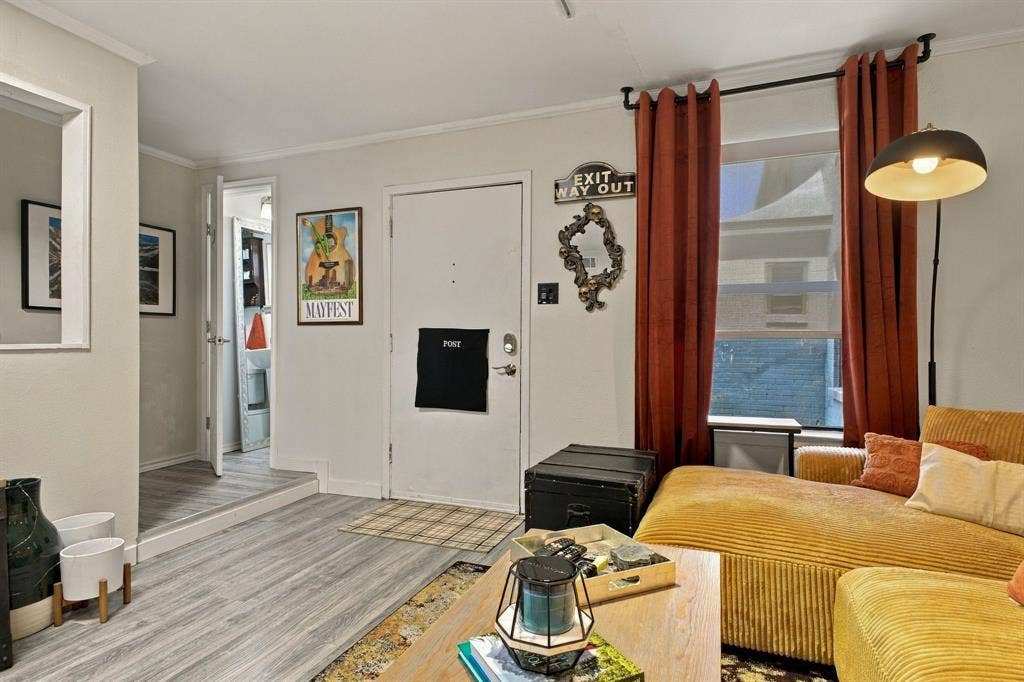 4904 Lahoma Street, #4904, Dallas, TX 75235 Living area featuring wood-finish flooring, a raised platform elevation, and a window with a curtain rod assembly