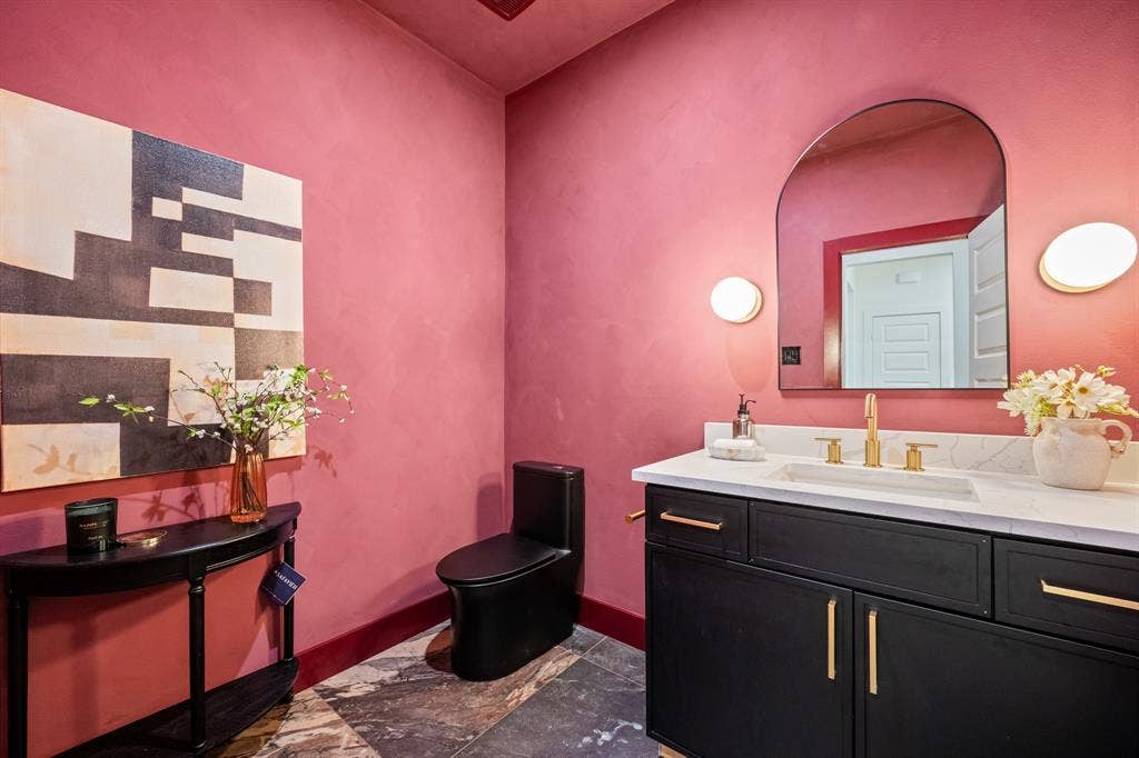 2719 Andrea Lane, Dallas, TX 75228 Burgundy lime wash walls with sconce lit vanity.