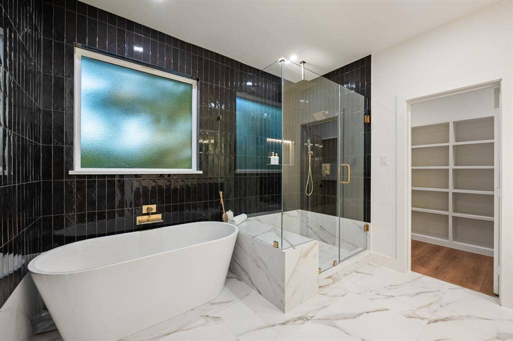 2719 Andrea Lane, Dallas, TX 75228 Primary bathroom with walk in shower and separate tub.