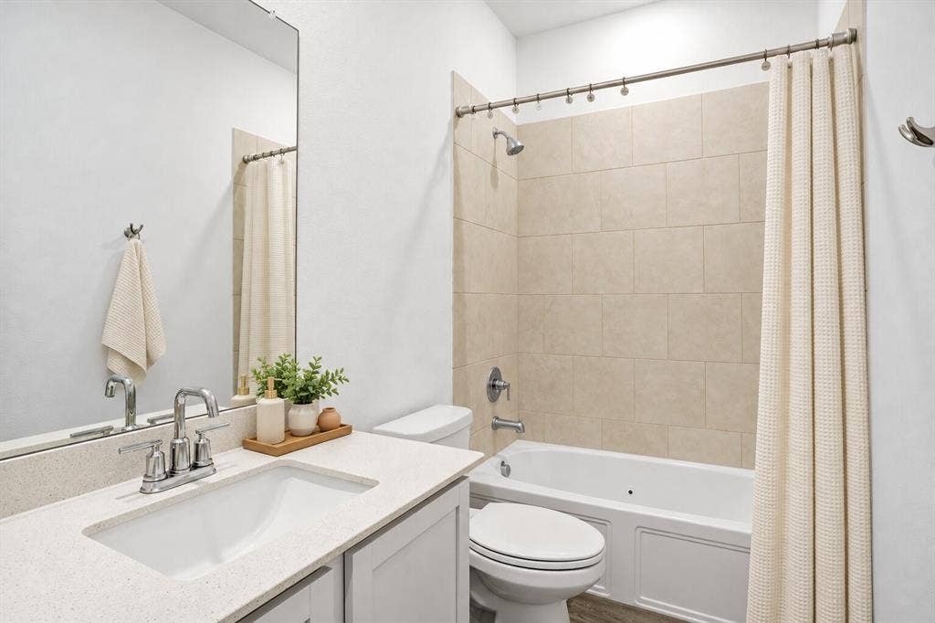 317 Red Cedar Drive, Princeton, TX 75407 Full bathroom between two of the secondary bedrooms; Photo has been digitally enhanced and/or virtually staged using AI.
