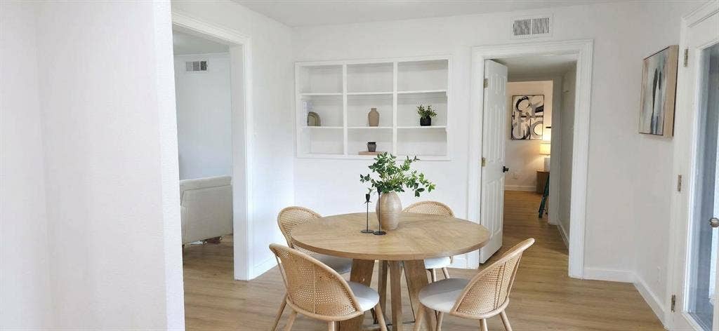 513 Vernet Street, Richardson, TX 75080 Built-in white recessed shelving, wood-finish flooring, and crisp white wall finish