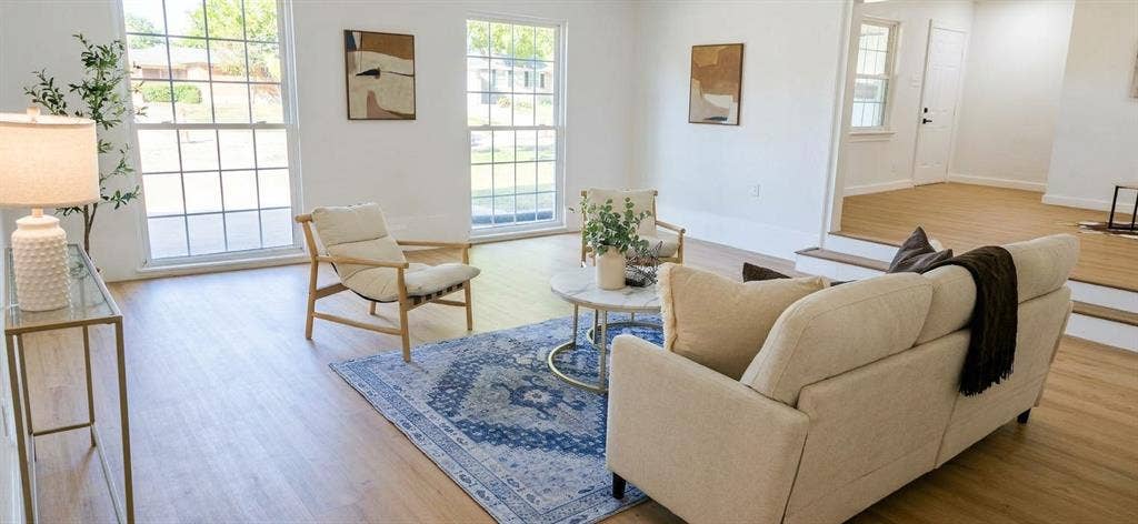 513 Vernet Street, Richardson, TX 75080 Bright living area featuring wood-finish flooring, multi-pane windows, and a raised platform level