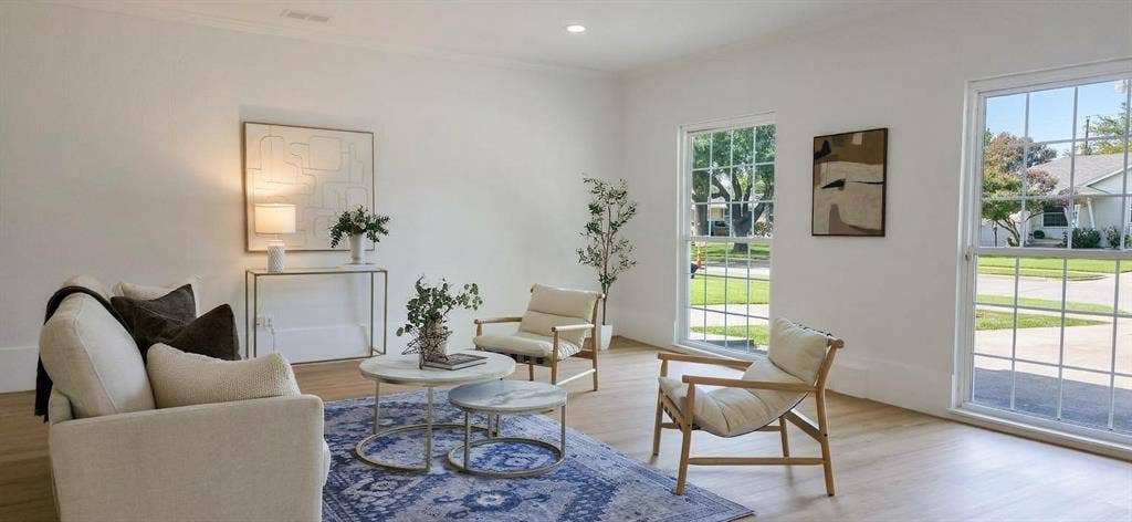 513 Vernet Street, Richardson, TX 75080 Neutral-toned interior featuring wood-finish flooring, recessed lighting, and expansive dual-pane windows with muntin detailing