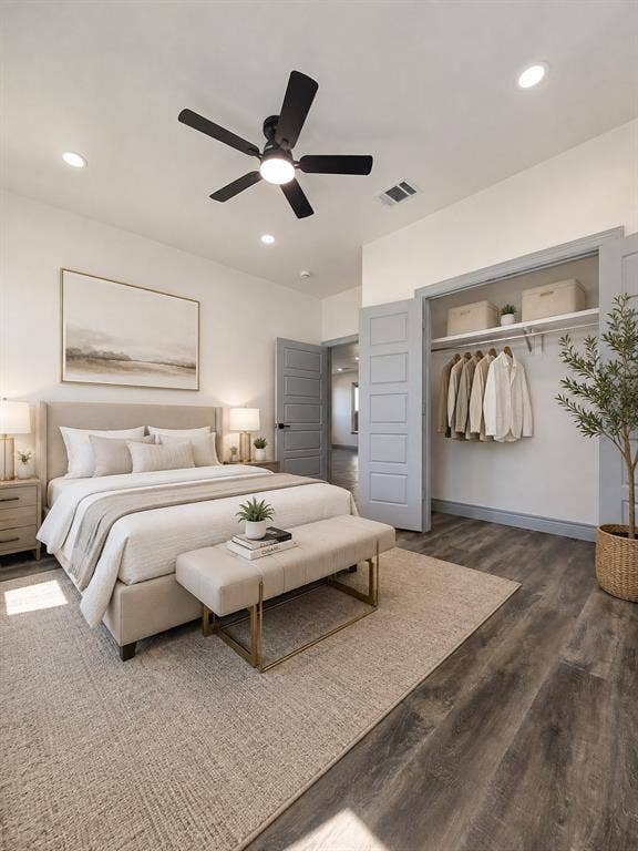 Bedroom interior featuring wood-finish flooring, recessed lighting, a matte black ceiling fan, and five-panel interior doors finished in slate gray