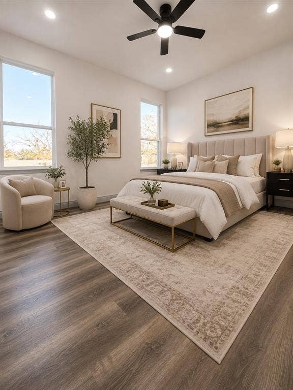 Wood-finish flooring, recessed lighting, multi-pane windows, and a matte black ceiling fan