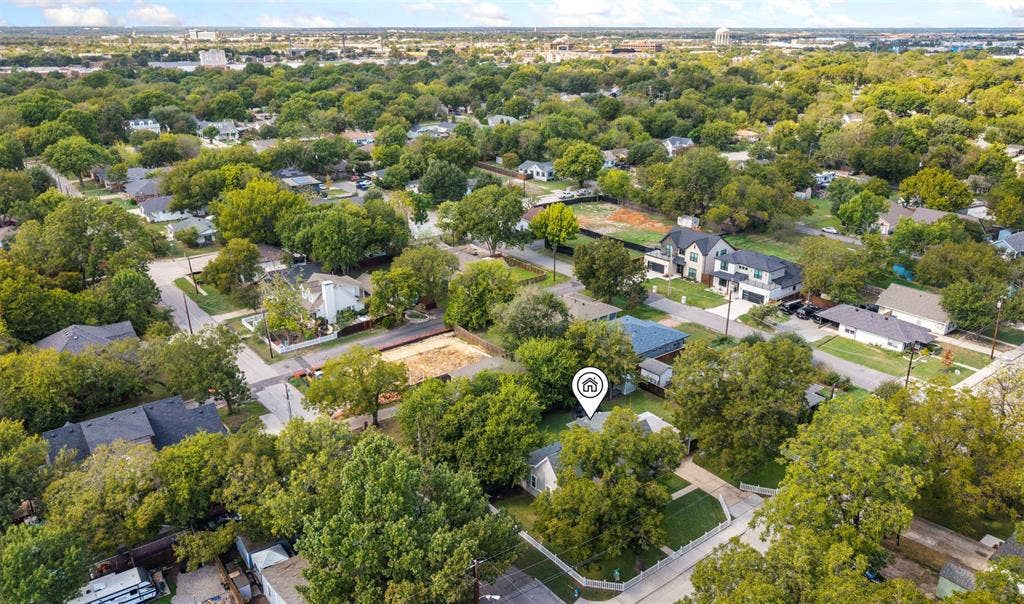 901 Oak Street, McKinney, TX 75069 Aerial view featuring a residential property with established tree coverage, a fenced perimeter, and a detached structure