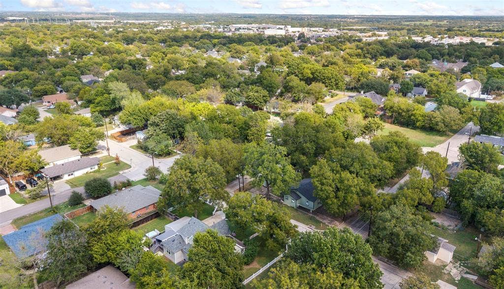 901 Oak Street, McKinney, TX 75069 Aerial perspective of a residential area characterized by dense tree canopy and established street infrastructure