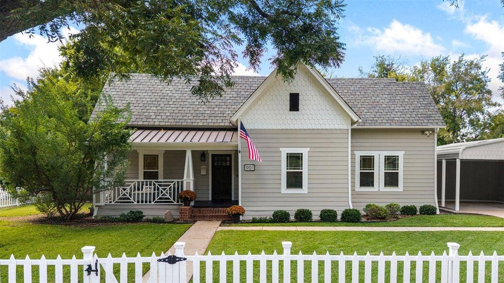 901 Oak Street, McKinney, TX 75069 Exterior facade featuring horizontal siding, decorative shingle gables, a covered front porch with lattice railing, and a side carport