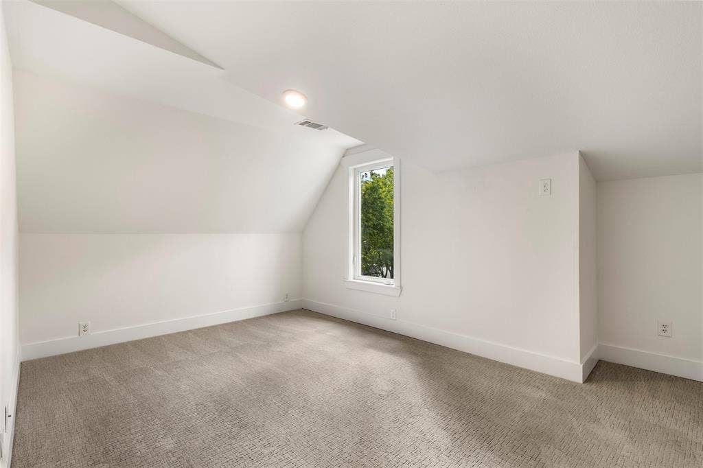 901 Oak Street, McKinney, TX 75069 Second Primary Upstairs! Sloped ceilings, neutral wall color, wall-to-wall carpeting, and a vertical sash window