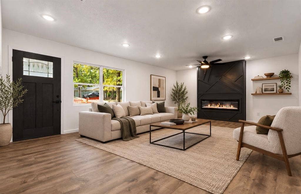 4813 Alandale Drive, Forest Hill, TX 76119 Living area featuring wood-finish flooring, recessed lighting, a fireplace with a geometric accent wall, a multi-pane entry door, and built-in wall shelving virtually staged