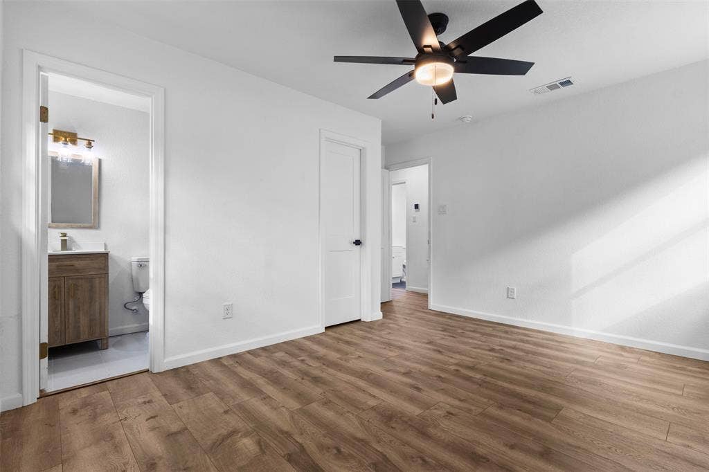 4813 Alandale Drive, Forest Hill, TX 76119 Wood-finish flooring, matte black ceiling fan with integrated lighting, and solid core interior doors