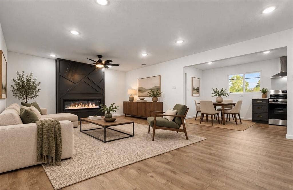 4813 Alandale Drive, Forest Hill, TX 76119 Living area featuring wood-finish flooring, recessed lighting, and a black geometric fireplace surround with an integrated linear firebox virtually staged