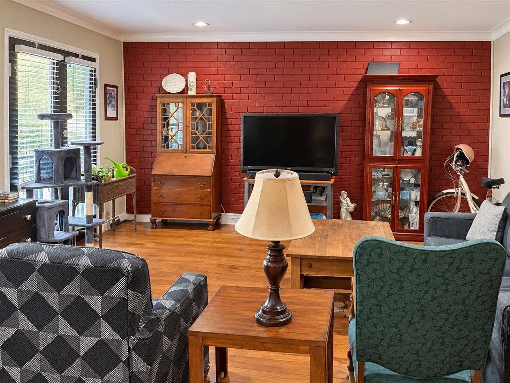 7730 Meadow Park Drive, #222, Dallas, TX 75230 Painted brick accent wall, wood-finish flooring, recessed lighting, crown molding, and glass-paneled double doors