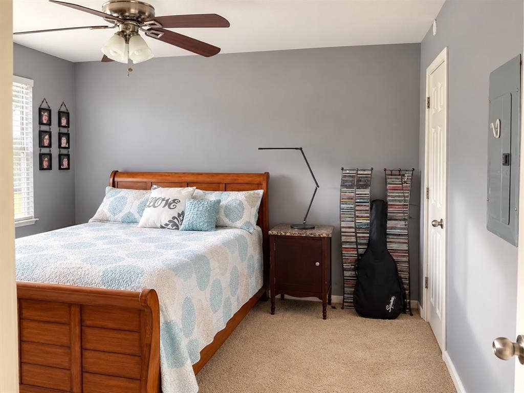 7730 Meadow Park Drive, #222, Dallas, TX 75230 Neutral-toned walls featuring neutral carpeting, a dual-tone ceiling fan with integrated lighting, and a multi-panel door