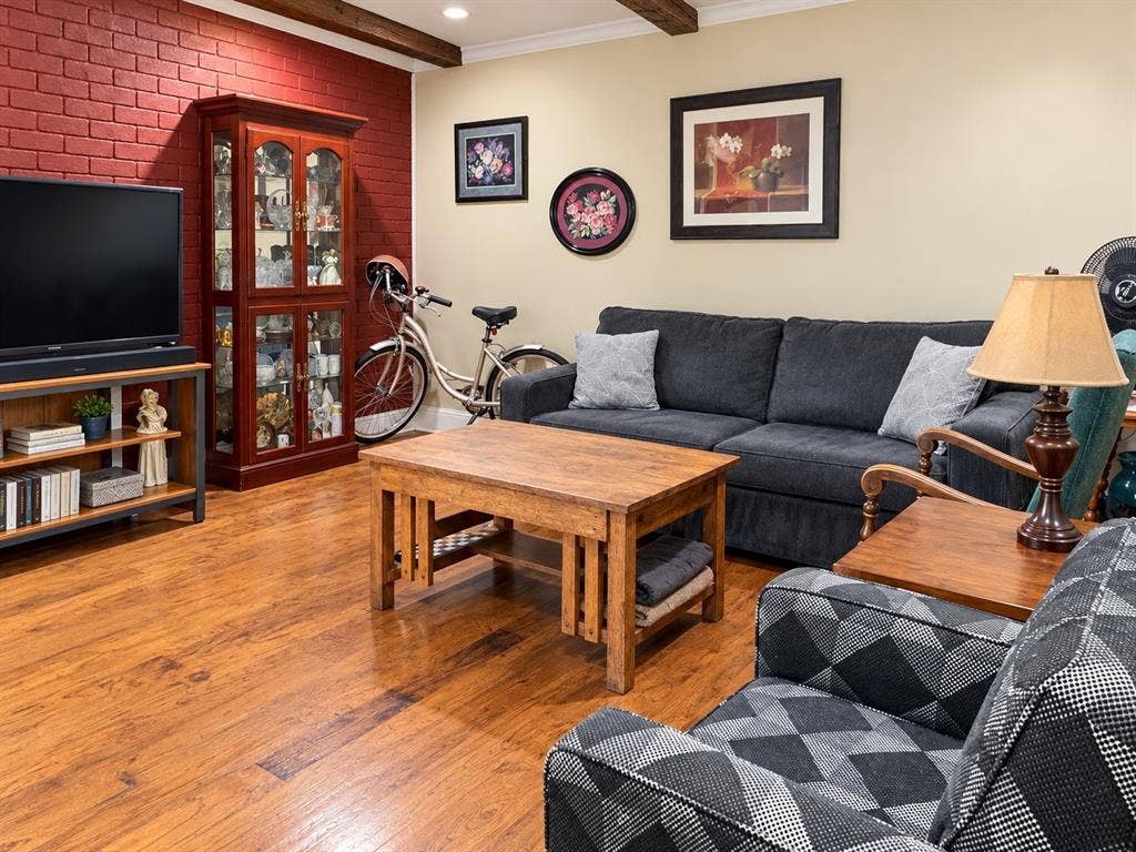 7730 Meadow Park Drive, #222, Dallas, TX 75230 Exposed wood-finish ceiling beams, brick accent wall, and wood-finish flooring