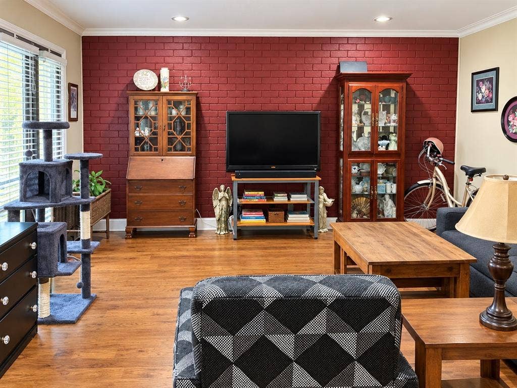 7730 Meadow Park Drive, #222, Dallas, TX 75230 Red brick accent wall, wood-finish flooring, and recessed ceiling lighting