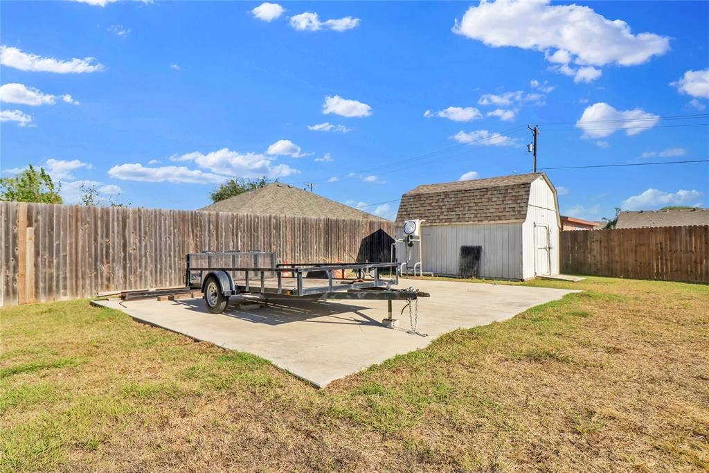 5753 Lionfish Way, Fort Worth, TX 76131 Parking pad and storage building.