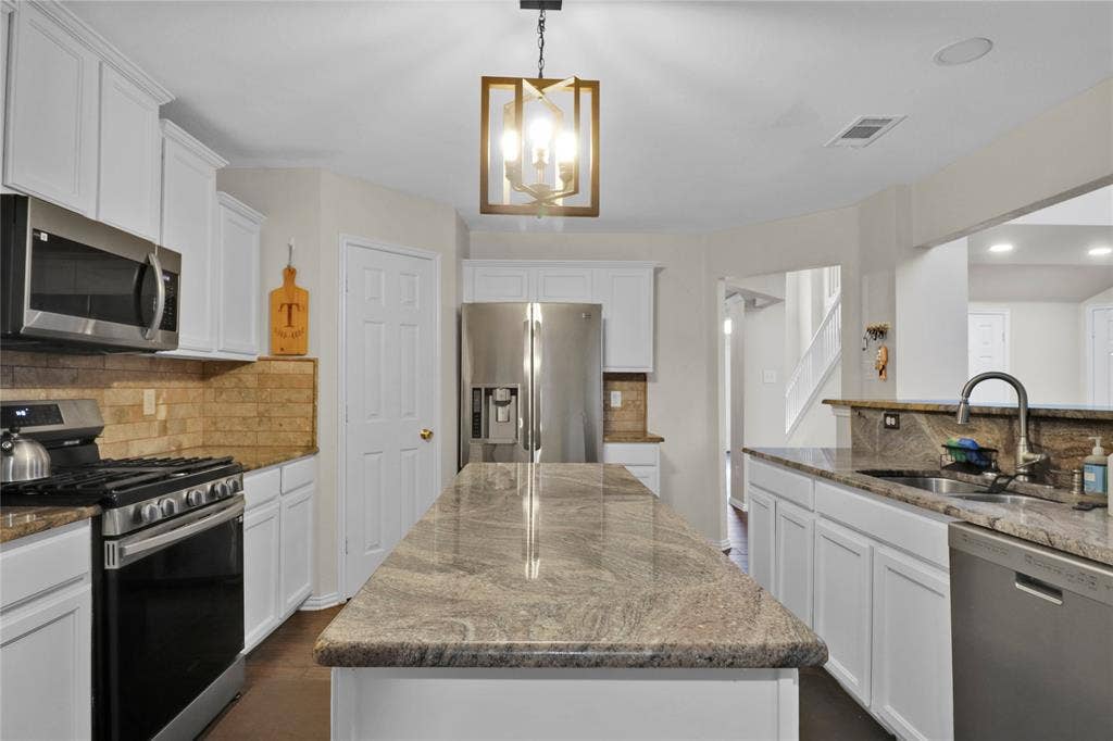 5753 Lionfish Way, Fort Worth, TX 76131 Kitchen with granite counters, long island for extra prep space, and SS appliances.