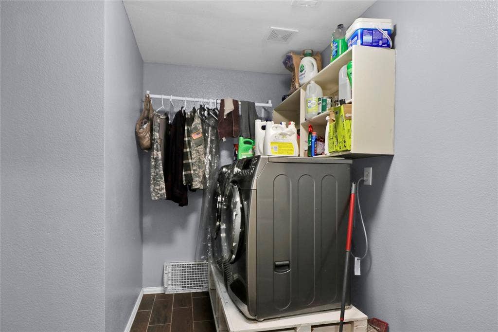 5753 Lionfish Way, Fort Worth, TX 76131 Laundry room with drying rack and shelves.