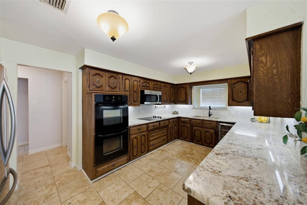 467 Harvest Glen Drive, Richardson, TX 75081 Kitchen featuring double ovens, lots of cabinet & counter space, window overlooking garden, wine cooler, built in microwave, undermount sink and pantry.