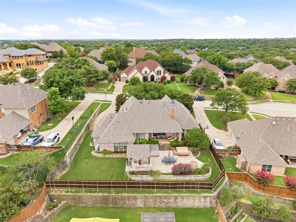 Expansive property featuring a stone patio, built-in hot tub, and an outdoor kitchen area