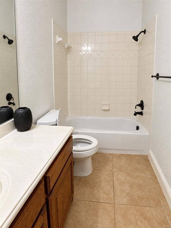 1731 Teakwood Drive, Wylie, TX 75098 Bathroom featuring a vanity with a light-toned countertop, ceramic tile flooring, a tub-shower combination with decorative tile surround, and matte black fixtures