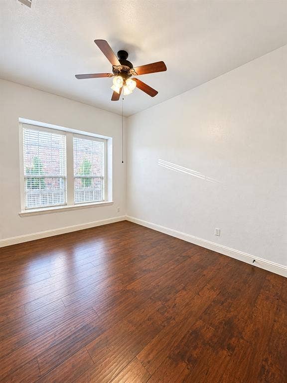 1731 Teakwood Drive, Wylie, TX 75098 Room featuring wood-finish flooring, dual-pane windows, and a ceiling fan with integrated lighting