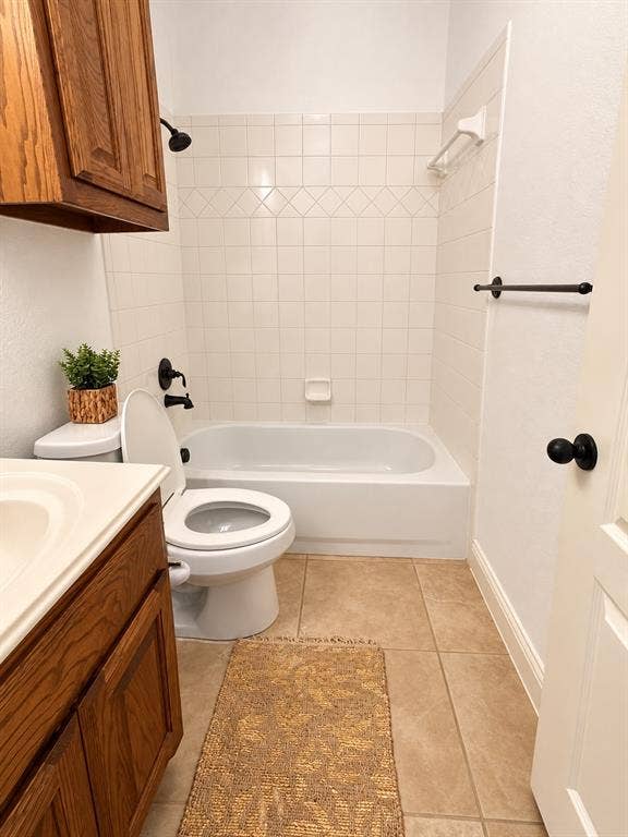 1731 Teakwood Drive, Wylie, TX 75098 Full bathroom featuring a tub-shower combination with white wall tile, wood-finish cabinetry, tile flooring, and matte black fixtures