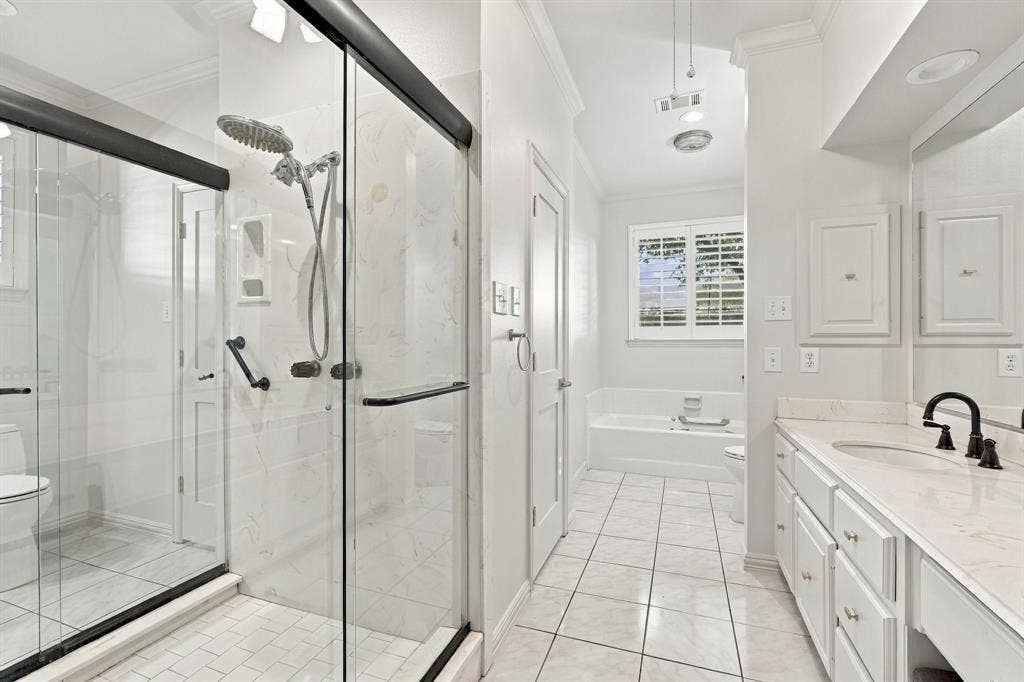 Dual bath area with generous counters, bathtub and shower.