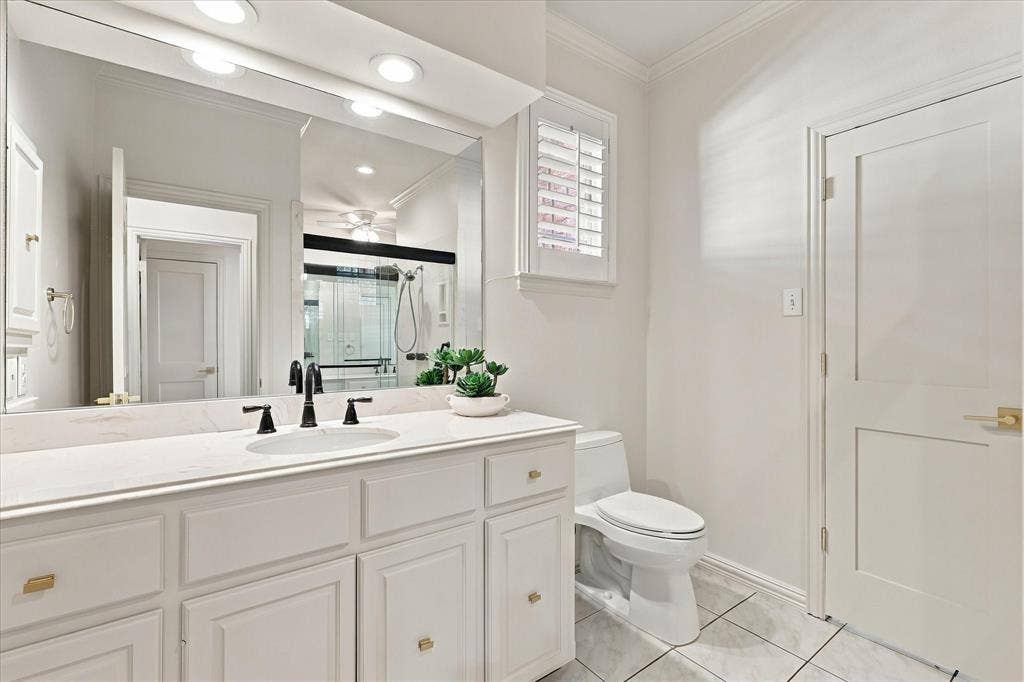 Dual bath area with generous counters, bathtub and shower.