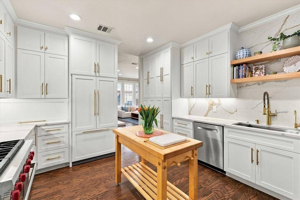 Shaker cabinets, Built in cabinet paneled refrigerator, and Wolf range.