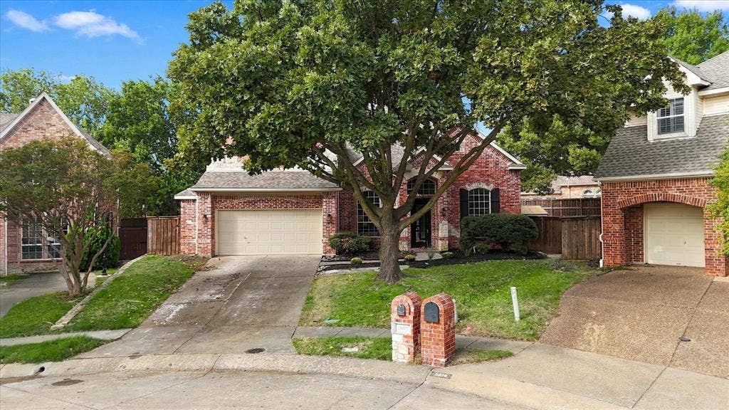 5609 Hillview Court, McKinney, TX 75072 Traditional brick exterior featuring arched entryways, multi-car garage space, and mature landscaping