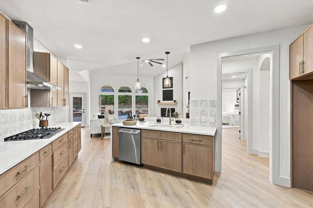 5609 Hillview Court, McKinney, TX 75072 Kitchen featuring light wood-finish cabinetry, white countertops, a stainless steel dishwasher, gas cooktop, and patterned tile backsplash