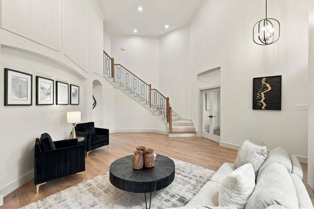 5609 Hillview Court, McKinney, TX 75072 Double-height ceilings featuring recessed lighting, expansive entryway with wood-finish flooring, and a staircase with metal balusters and wood handrail