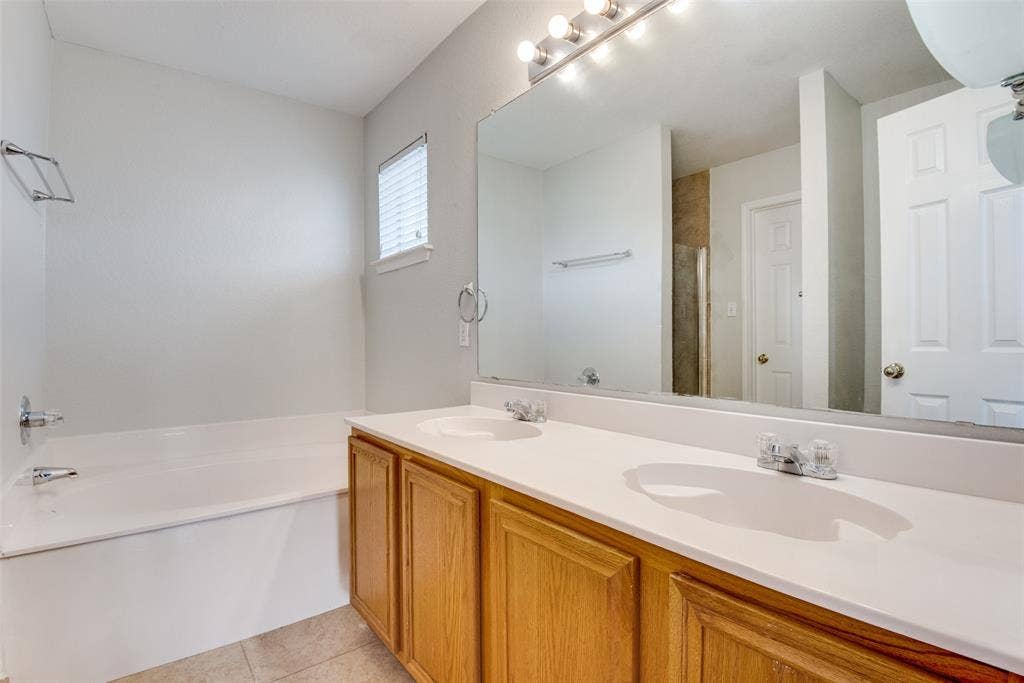 5329 Raven Row, Dallas, TX 75236 Bathroom with dual vanity, tile patterned floors, and a bathing tub