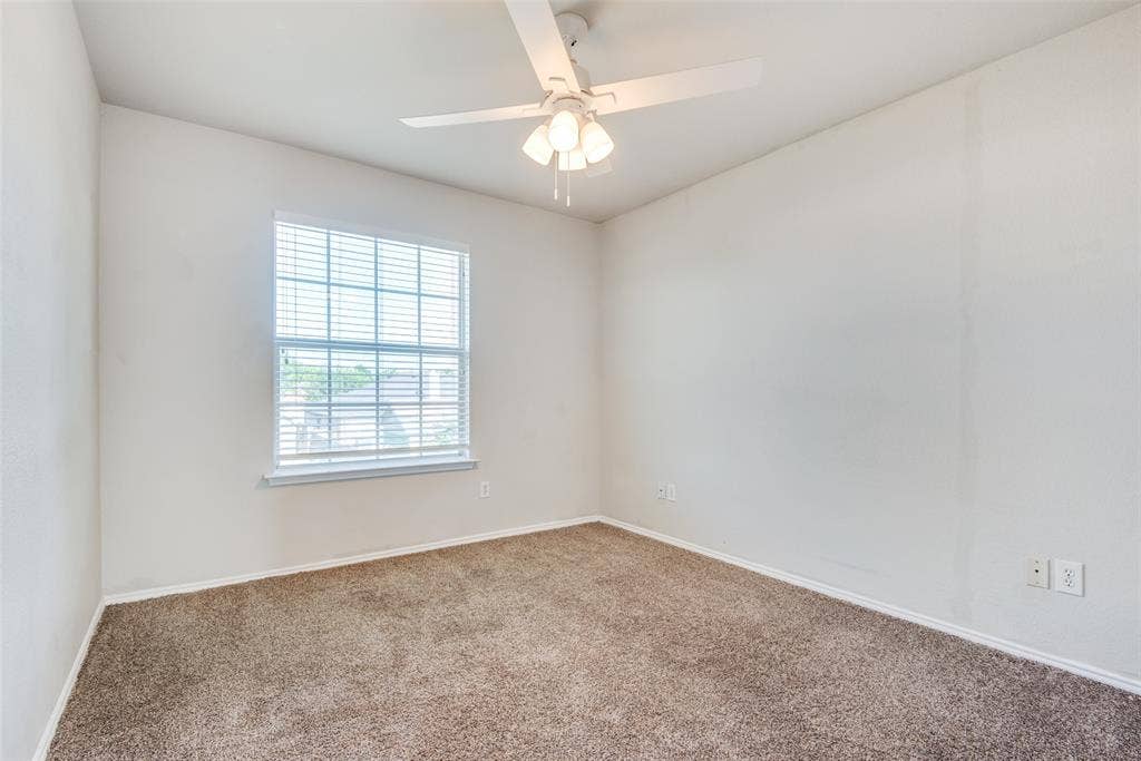 5329 Raven Row, Dallas, TX 75236 Empty room with carpet flooring and ceiling fan