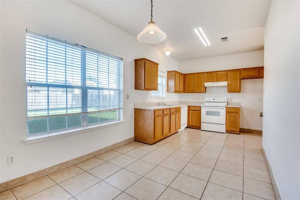 5329 Raven Row, Dallas, TX 75236 Kitchen featuring sink, hanging light fixtures, white appliances, and light tile patterned floors