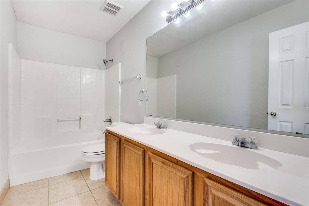 5329 Raven Row, Dallas, TX 75236 Full bathroom featuring shower / bathtub combination, tile patterned flooring, toilet, and double sink vanity