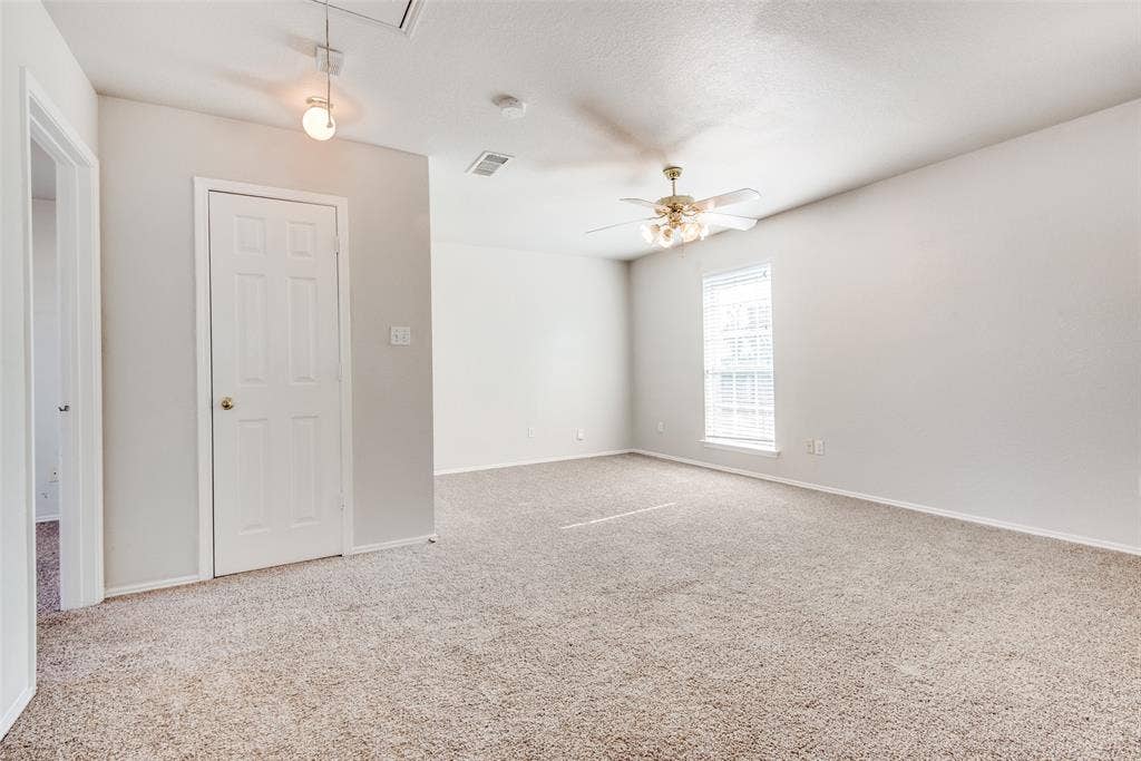 5329 Raven Row, Dallas, TX 75236 Carpeted spare room with ceiling fan