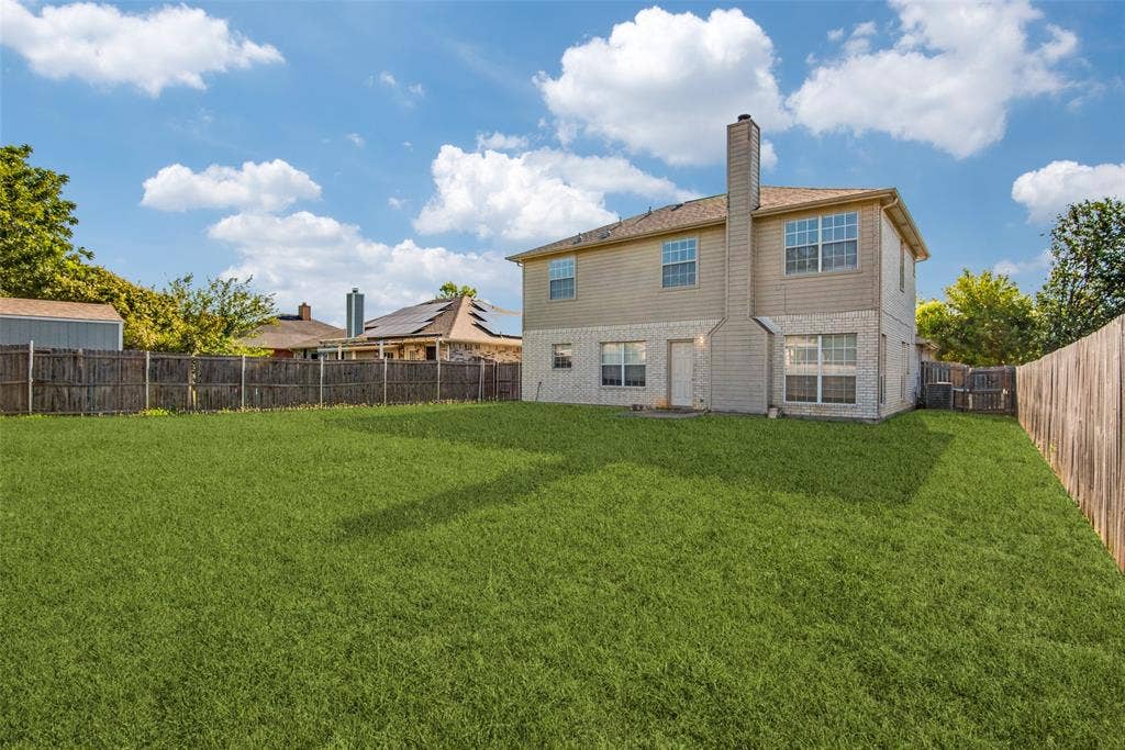 5329 Raven Row, Dallas, TX 75236 Rear view of property featuring a yard